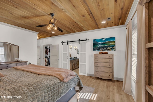 309 W Cleveland Ave, Monterey, TN 38574 - bedroom featuring multiple windows, a barn door, wooden ceiling, and light wood-type flooring