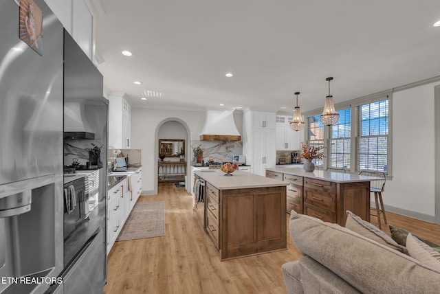 309 W Cleveland Ave, Monterey, TN 38574 - kitchen featuring custom exhaust hood, white cabinetry, hanging light fixtures, and a center island