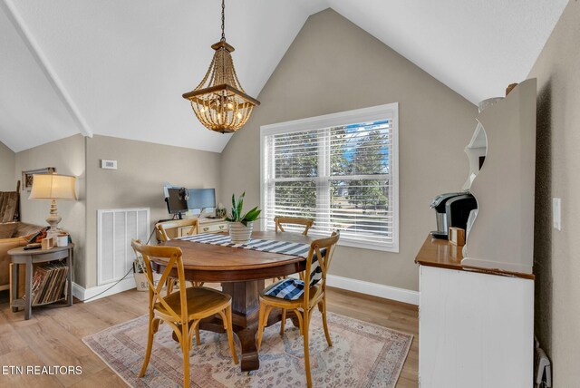 309 W Cleveland Ave, Monterey, TN 38574 - dining room with a notable chandelier, vaulted ceiling, and light wood-type flooring