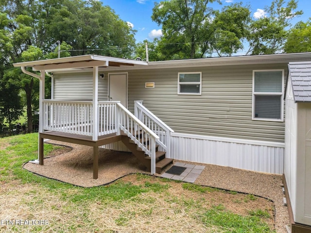 exterior space with a deck and a lawn