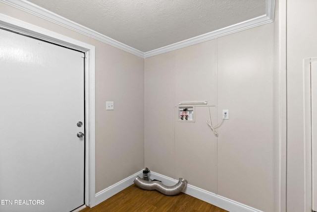 clothes washing area with washer hookup, wood-type flooring, a textured ceiling, and ornamental molding