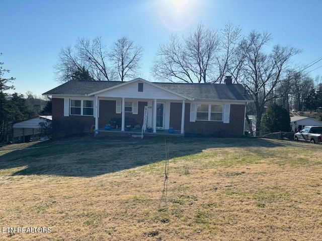 ranch-style house with covered porch and a front lawn