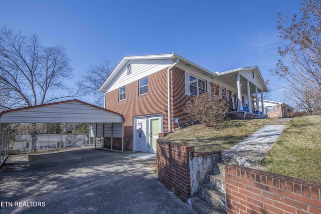 view of side of property featuring a carport and covered porch