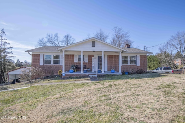 view of front of property featuring a front lawn and covered porch