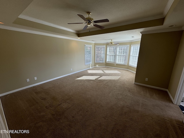 carpeted empty room featuring ornamental molding, ceiling fan, a textured ceiling, and a tray ceiling