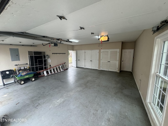 garage featuring a garage door opener and electric panel