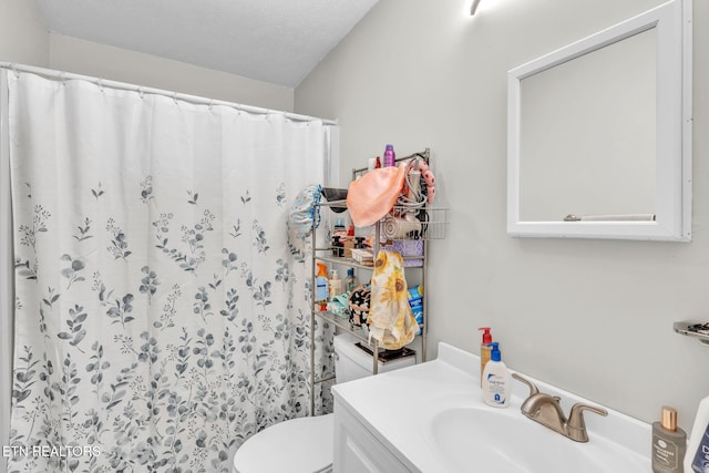 bathroom with vanity, a shower with shower curtain, a textured ceiling, and toilet