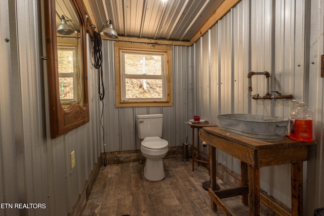 bathroom featuring sink, hardwood / wood-style floors, and toilet