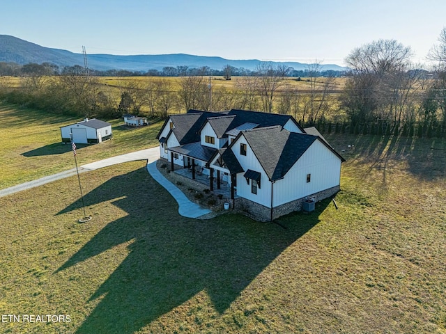 drone / aerial view with a mountain view and a rural view