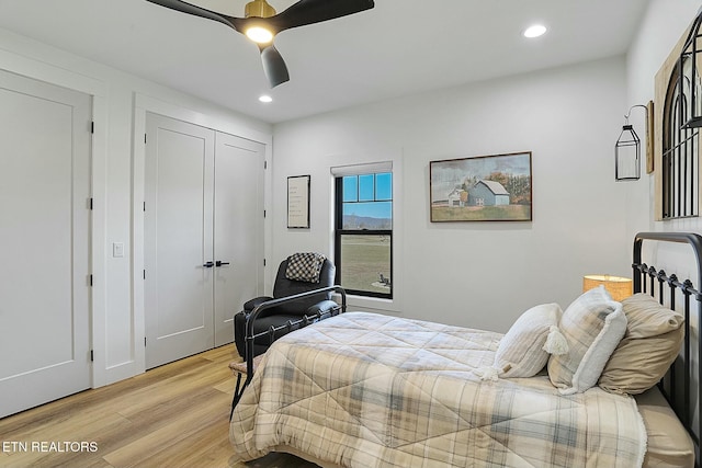 bedroom featuring ceiling fan and light hardwood / wood-style flooring