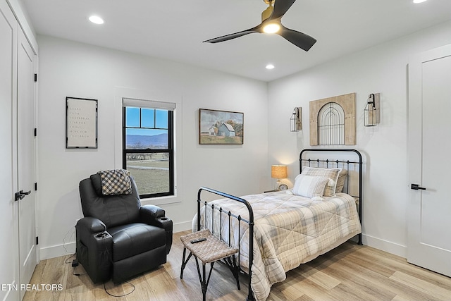 bedroom with ceiling fan and light hardwood / wood-style floors