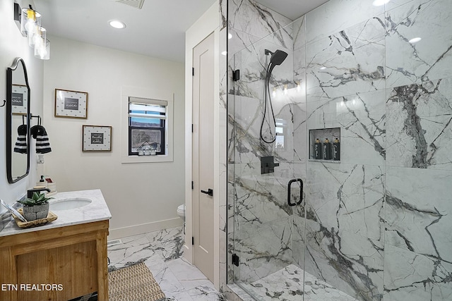 bathroom featuring vanity, an enclosed shower, and toilet