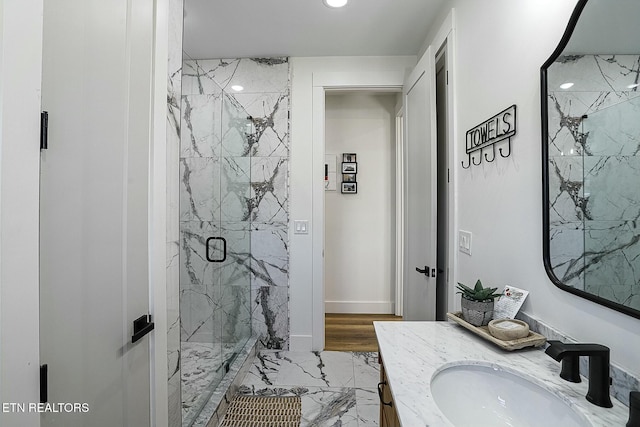 bathroom with vanity and a shower with door