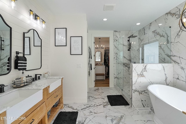 bathroom with vanity and shower with separate bathtub