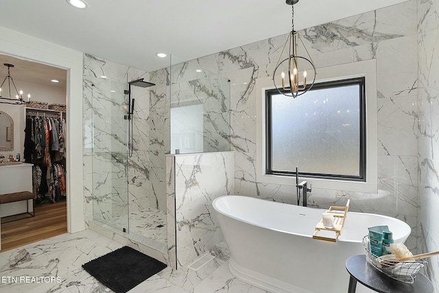 bathroom featuring a notable chandelier and independent shower and bath