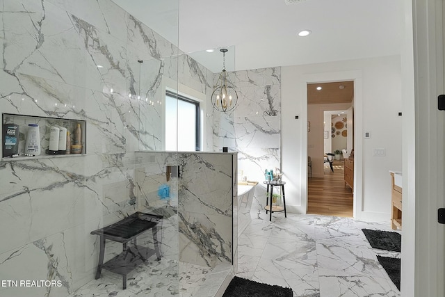 bathroom with an inviting chandelier and walk in shower