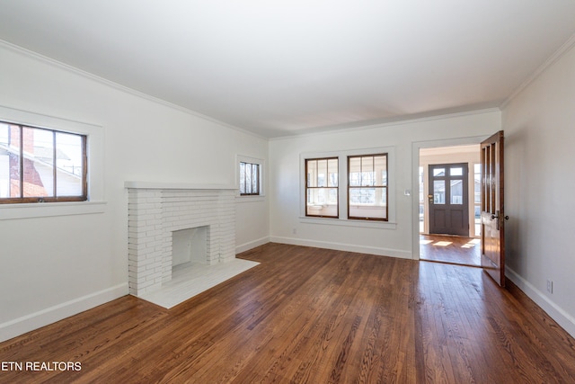 unfurnished living room with plenty of natural light, a fireplace, baseboards, and dark wood-style flooring