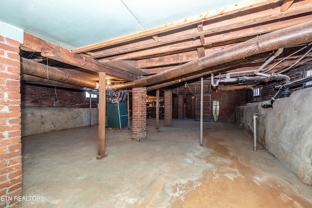 unfinished basement featuring heating unit