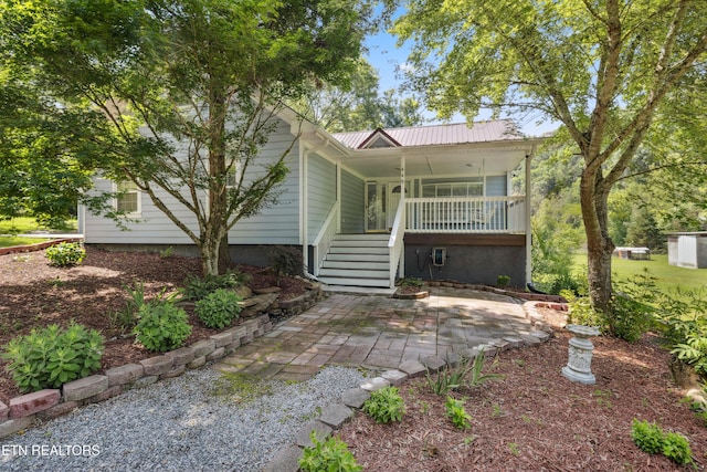 back of property with a porch