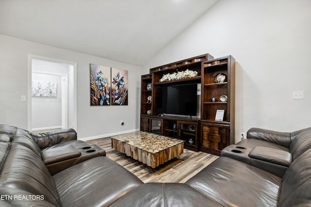 living room with lofted ceiling and hardwood / wood-style floors