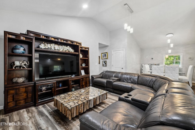 living room featuring dark wood-type flooring and high vaulted ceiling