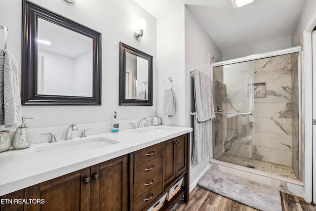 bathroom featuring vanity, hardwood / wood-style floors, and a shower with shower door