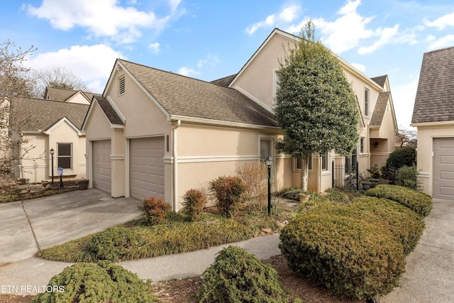 view of front of property featuring a shingled roof and stucco siding