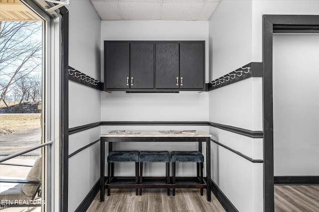 stairway featuring hardwood / wood-style flooring and a paneled ceiling