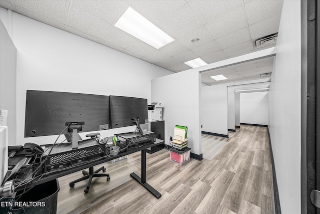 office area with wood-type flooring and a drop ceiling