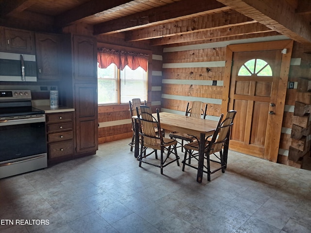 dining area with wooden walls, wooden ceiling, and beamed ceiling