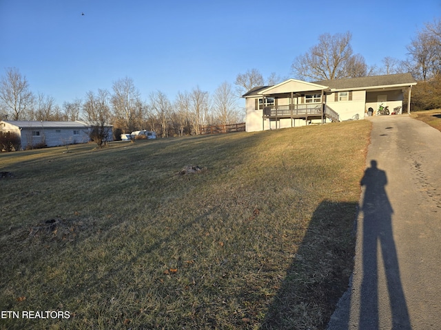 view of front of house with a carport and a front lawn