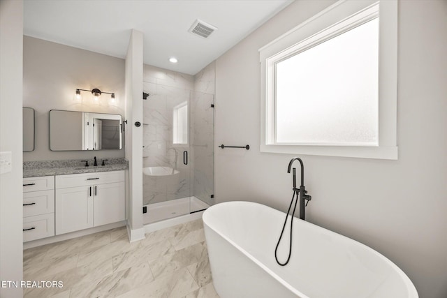 bathroom featuring vanity and separate shower and tub