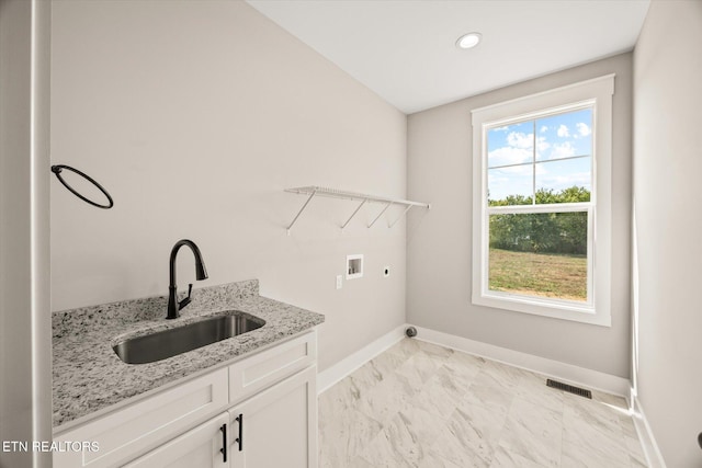 washroom with washer hookup, sink, cabinets, and electric dryer hookup