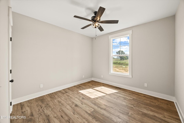 empty room with hardwood / wood-style flooring and ceiling fan