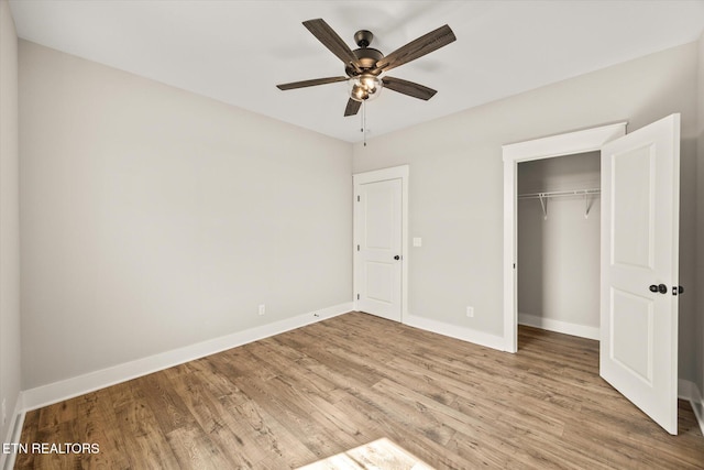 unfurnished bedroom featuring a closet, ceiling fan, and light wood-type flooring