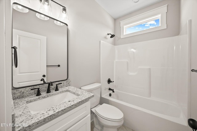 full bathroom featuring vanity, bathing tub / shower combination, and toilet