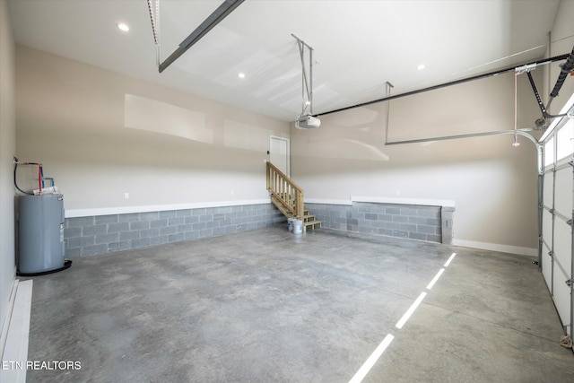 garage featuring a garage door opener and electric water heater