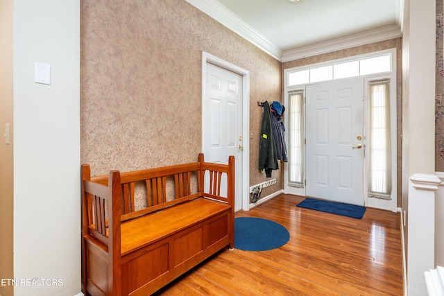 entrance foyer featuring crown molding and wood-type flooring