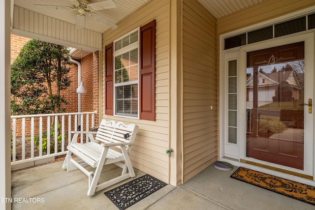 entrance to property with covered porch and ceiling fan