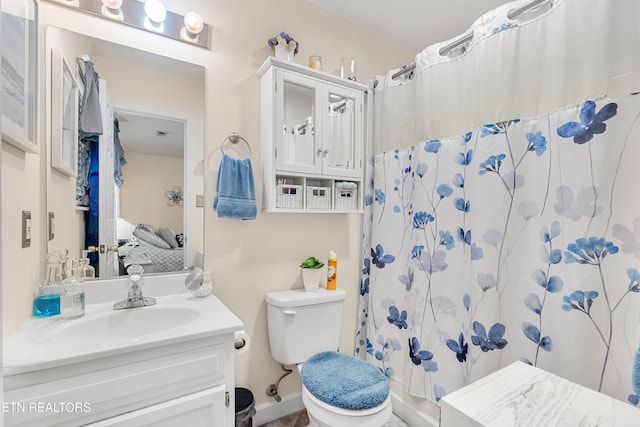 bathroom featuring vanity, toilet, and a shower with shower curtain