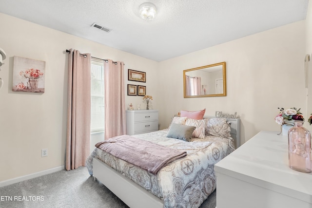 bedroom featuring carpet floors and a textured ceiling