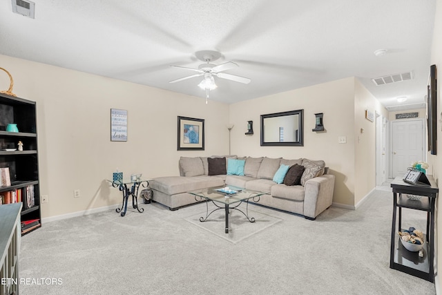 carpeted living room with a textured ceiling and ceiling fan