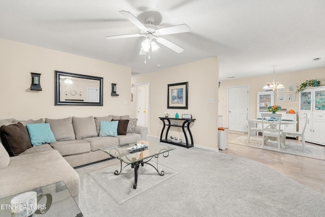 living room with ceiling fan and light hardwood / wood-style flooring