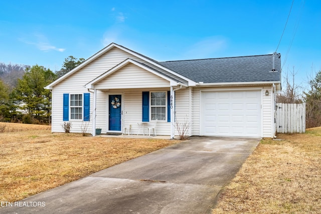 ranch-style house featuring a garage, covered porch, and a front lawn