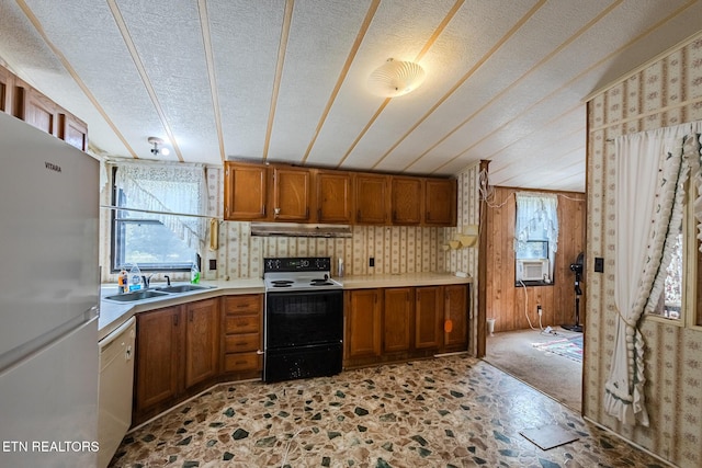 kitchen featuring sink, cooling unit, stainless steel refrigerator, white dishwasher, and electric stove