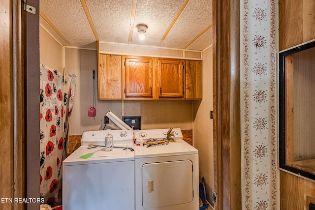 washroom featuring cabinets and independent washer and dryer