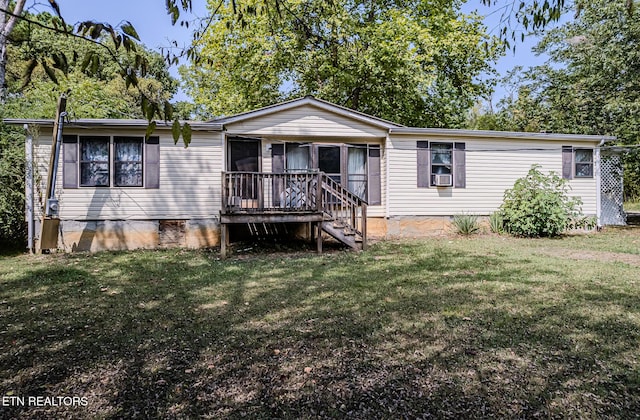 view of front of house with a front yard, a deck, and cooling unit