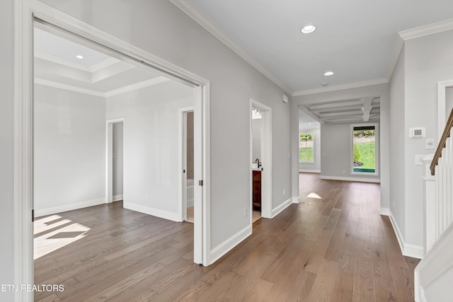 corridor with hardwood / wood-style flooring and ornamental molding