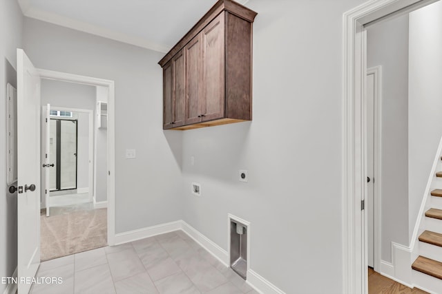 washroom with electric dryer hookup, washer hookup, light tile patterned floors, and cabinets