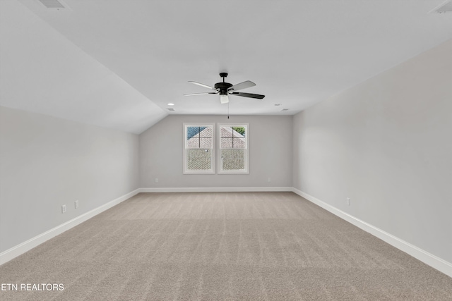 bonus room with ceiling fan, vaulted ceiling, and light carpet